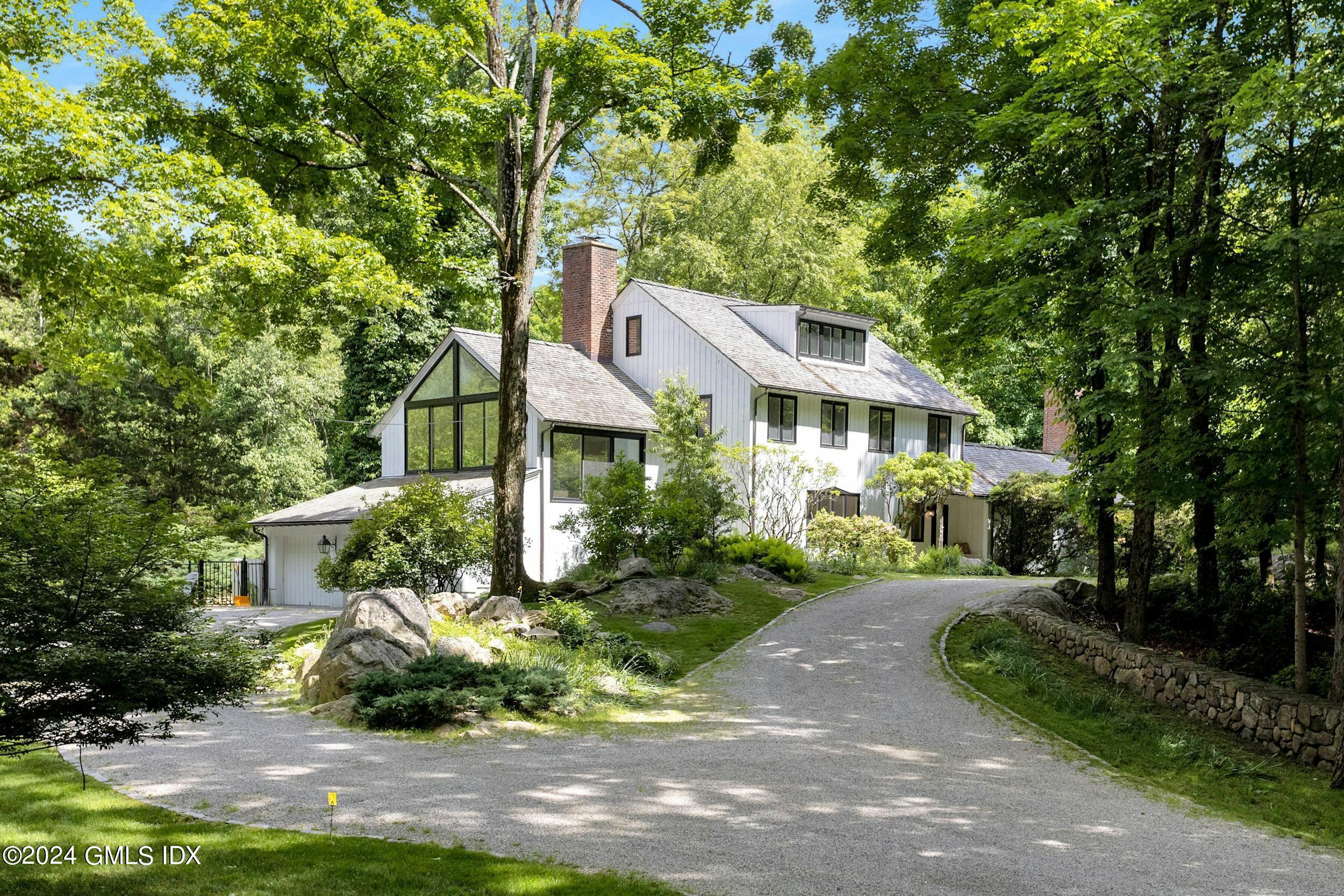 a front view of a house with a yard and green space