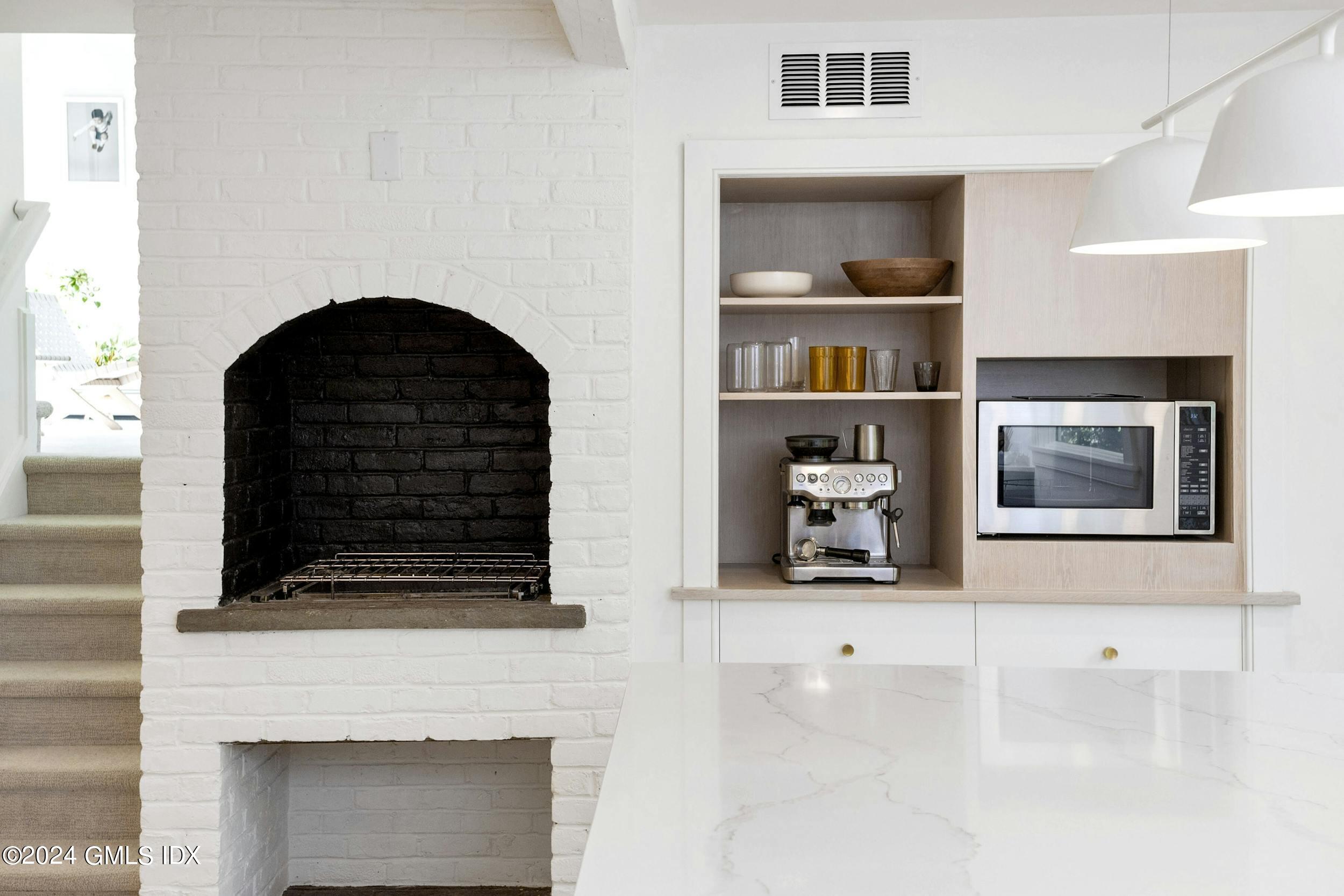 12 Guinea Road Greenwich, CT 06830 - Photo 12 of 38 a living room with fireplace and a book shelf