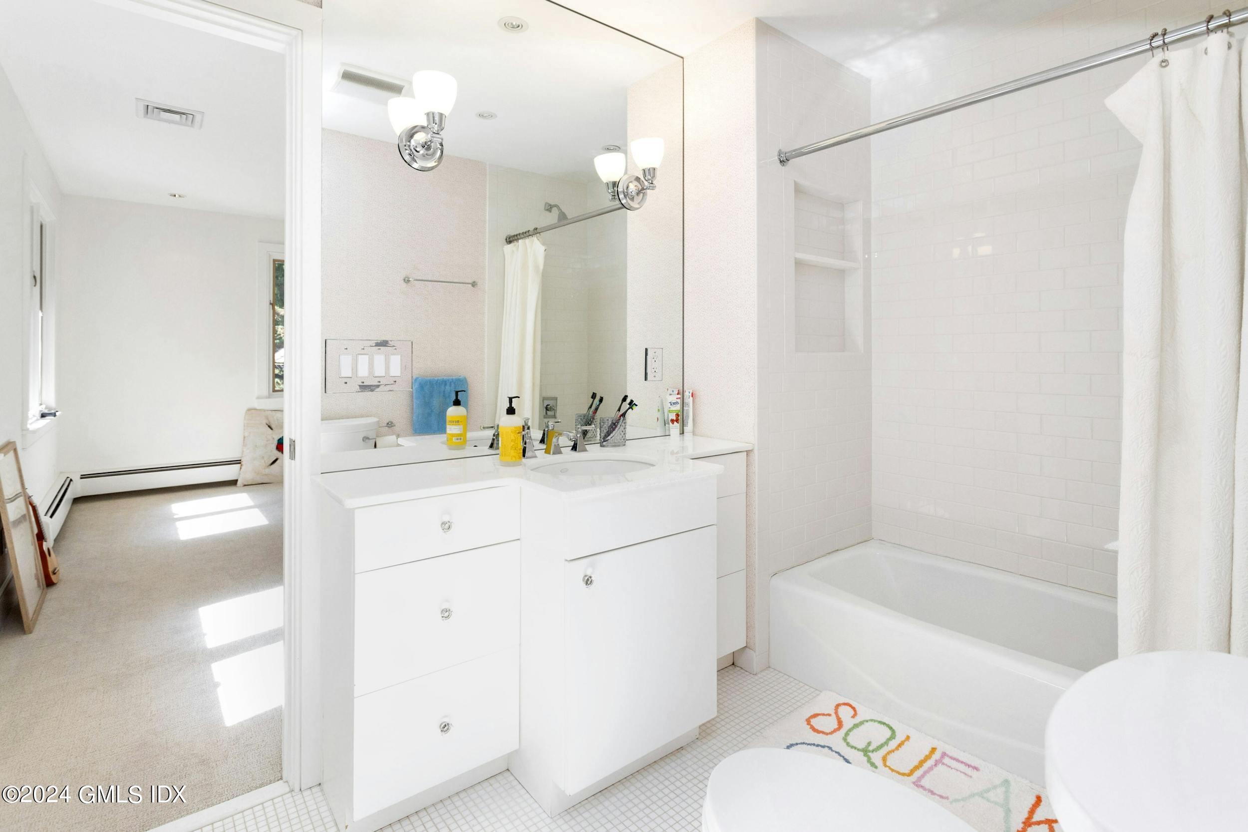 12 Guinea Road Greenwich, CT 06830 - Photo 21 of 38 a bathroom with a tub sink and a mirror