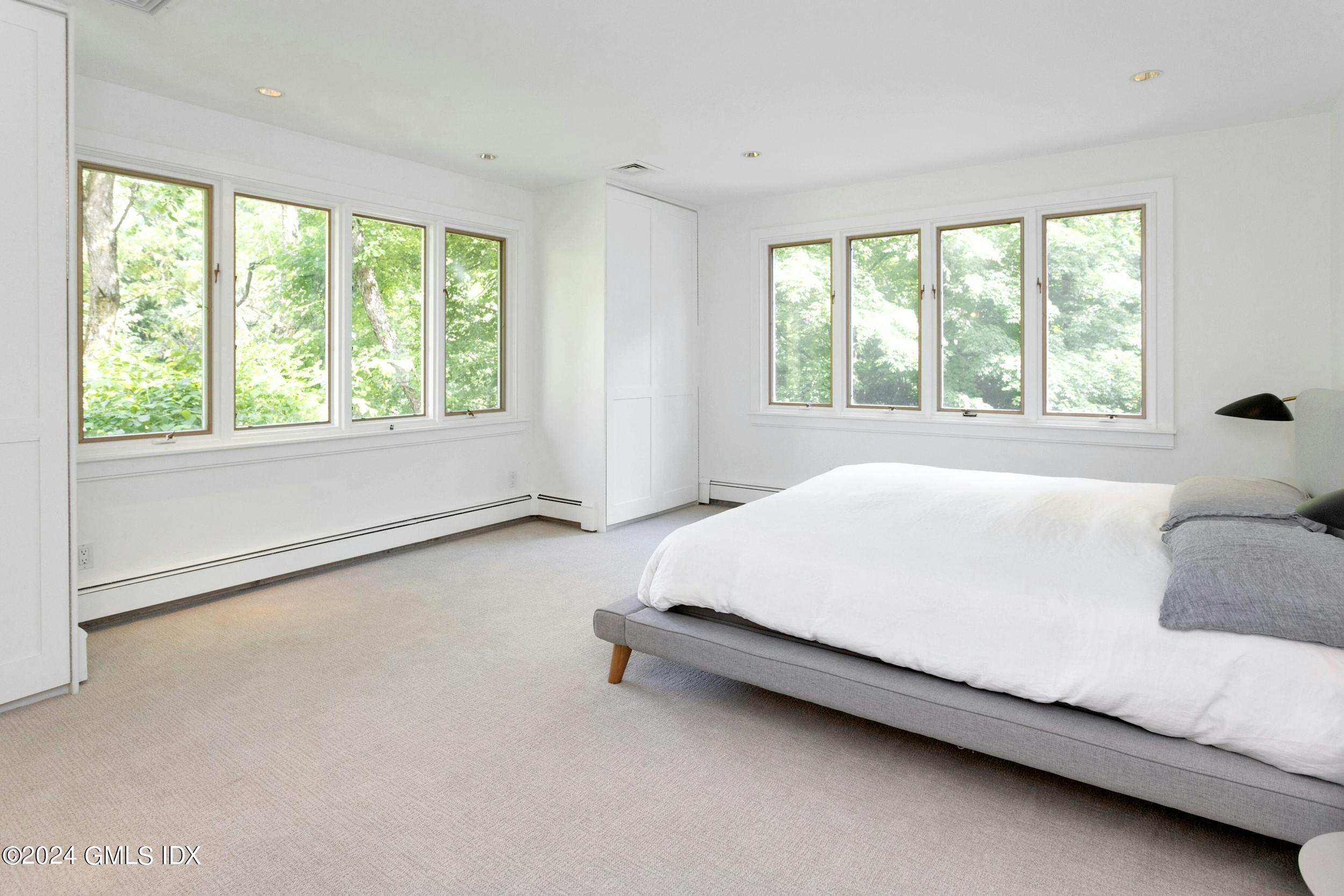 12 Guinea Road Greenwich, CT 06830 - Photo 23 of 38 a bed sitting in a bedroom next to a window