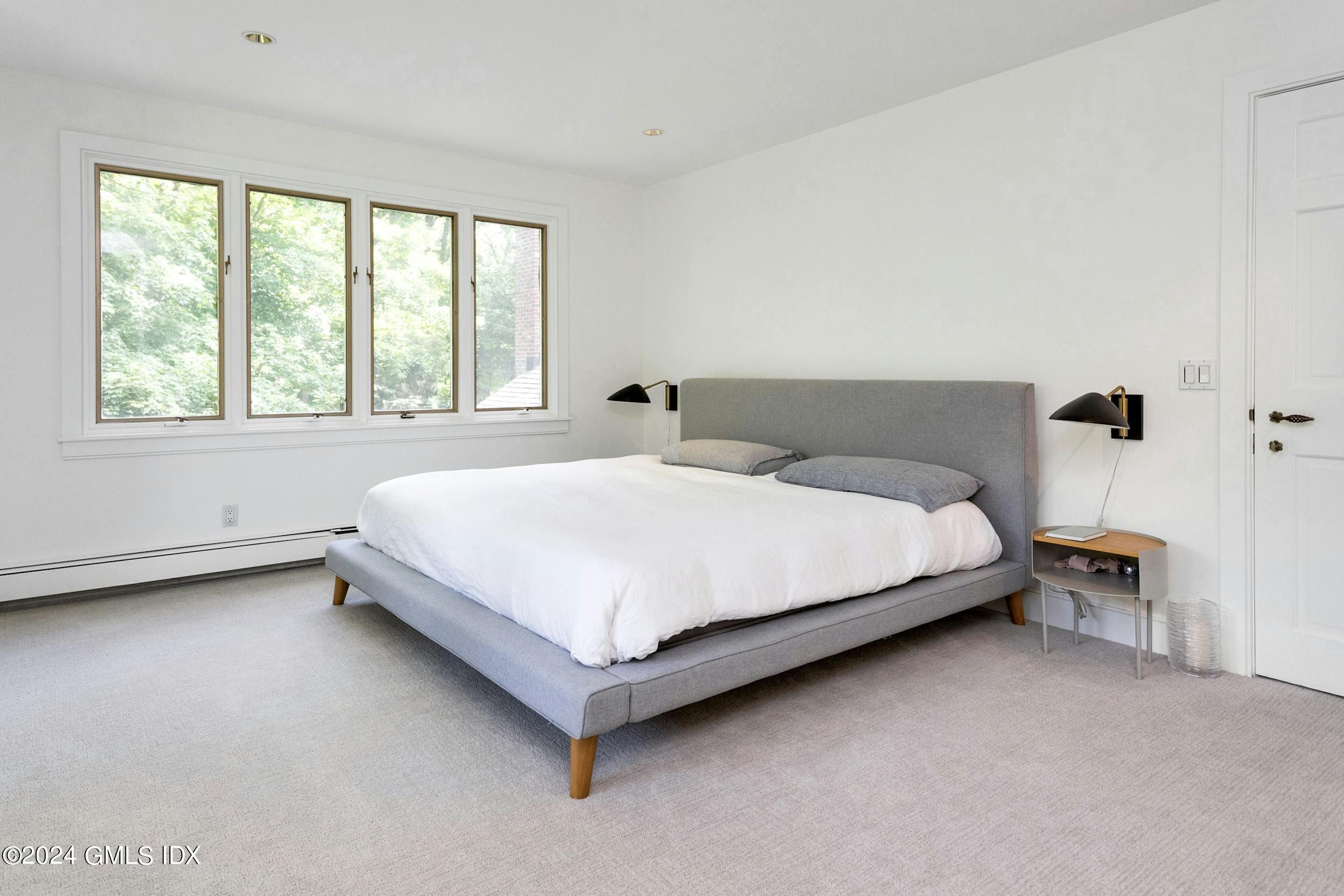 12 Guinea Road Greenwich, CT 06830 - Photo 24 of 38 a large bed sitting in a bedroom next to a window