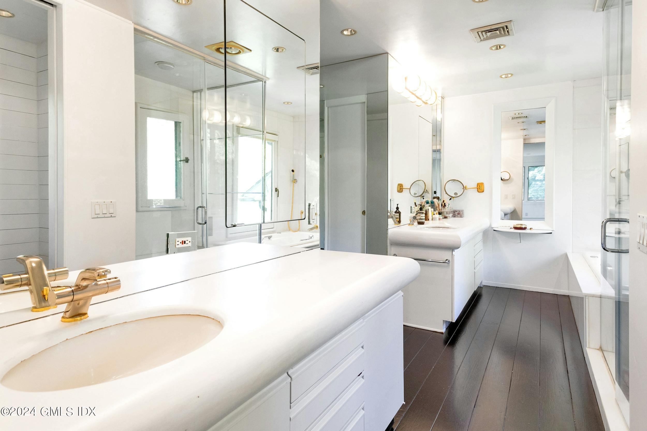 12 Guinea Road Greenwich, CT 06830 - Photo 25 of 38 a spacious en suite bathroom with a double vanity sink a mirror and a shower