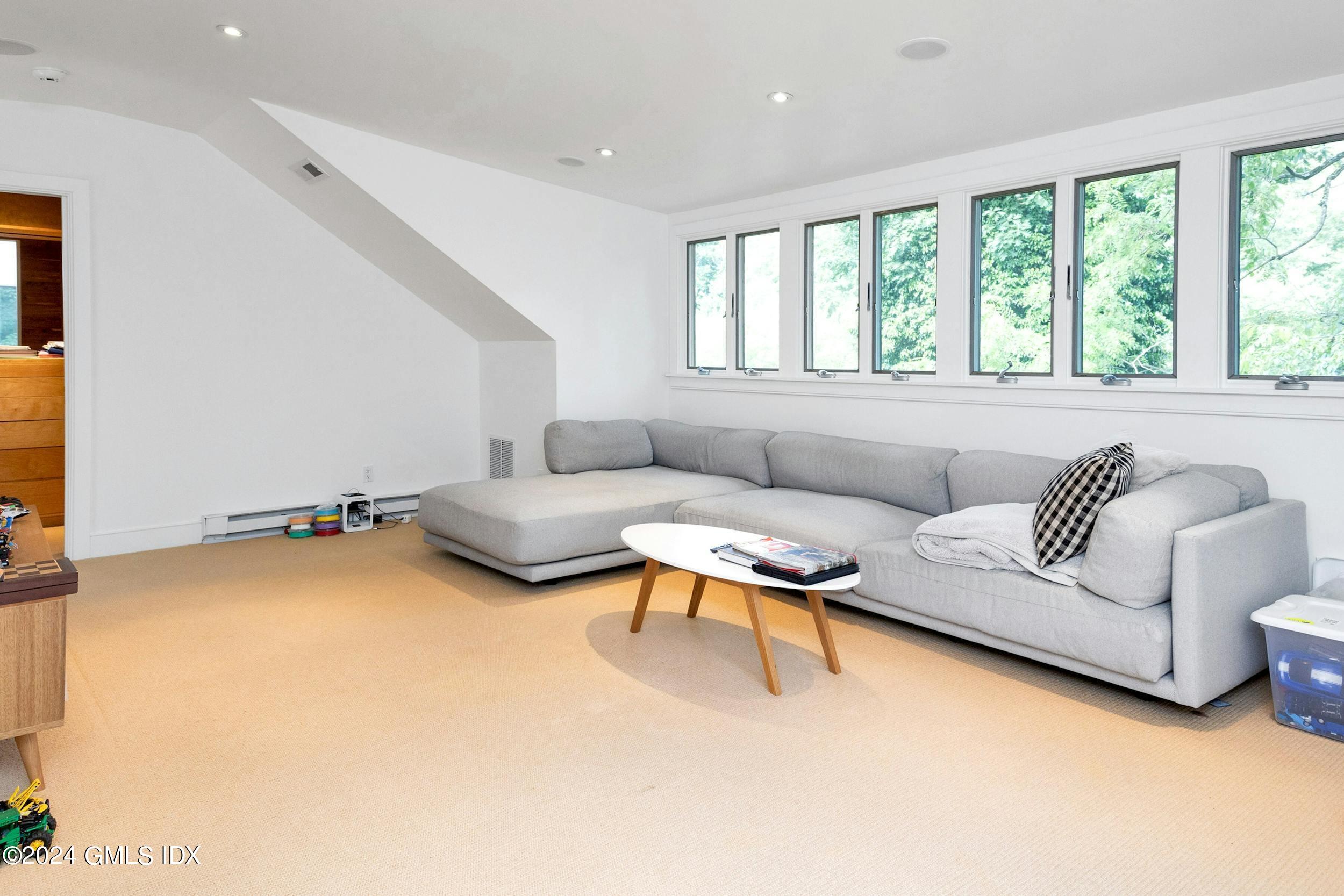 12 Guinea Road Greenwich, CT 06830 - Photo 27 of 38 a living room with furniture and a large window
