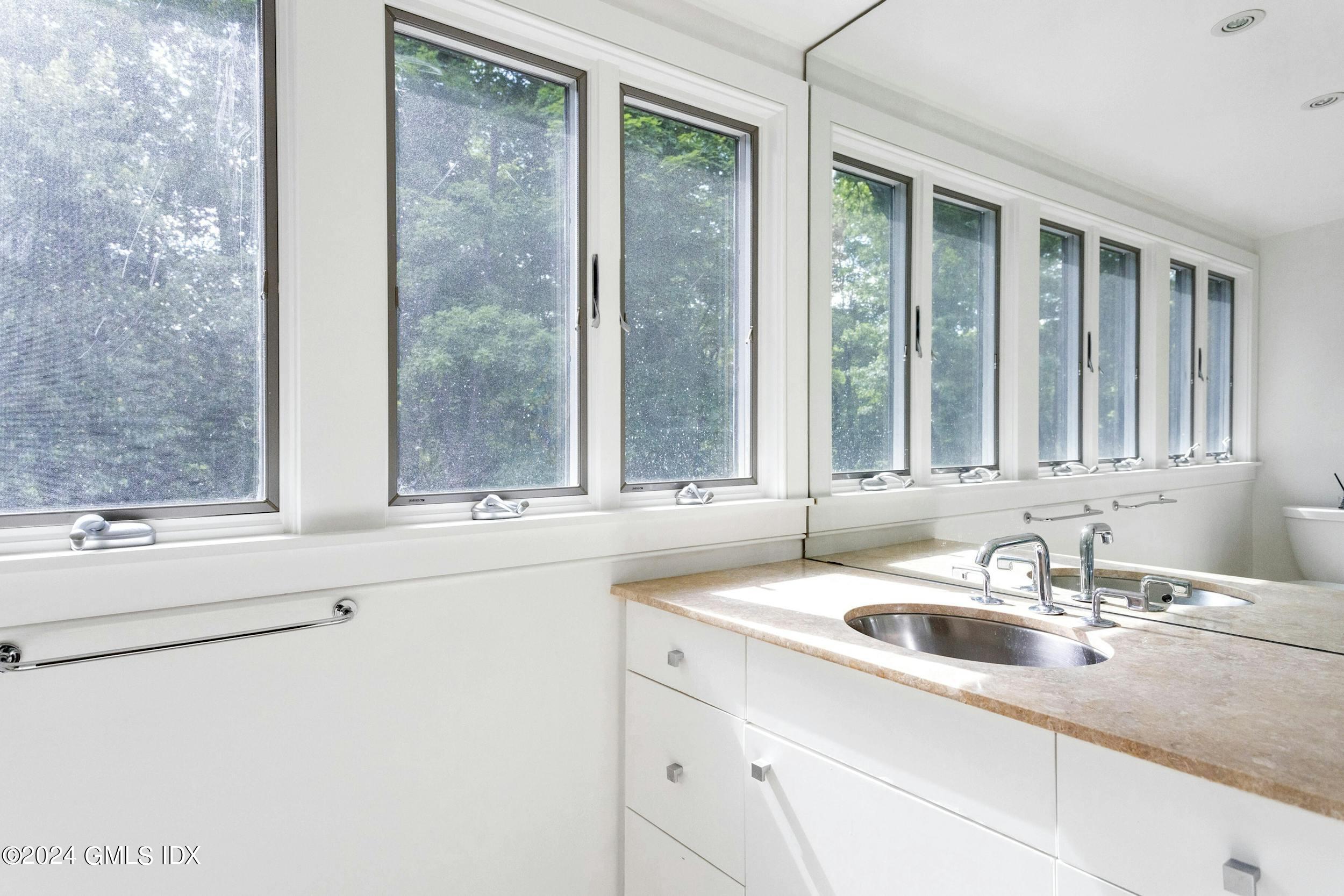 12 Guinea Road Greenwich, CT 06830 - Photo 28 of 38 a bathroom with a sink and a window