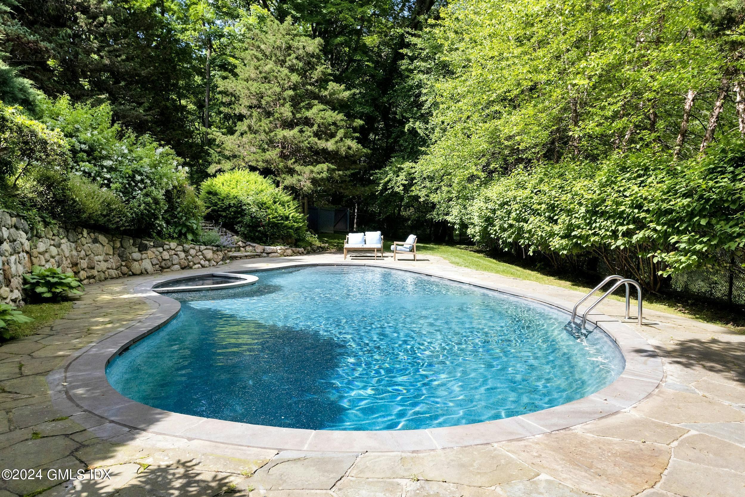 12 Guinea Road Greenwich, CT 06830 - Photo 29 of 38 a view of a swimming pool with a yard
