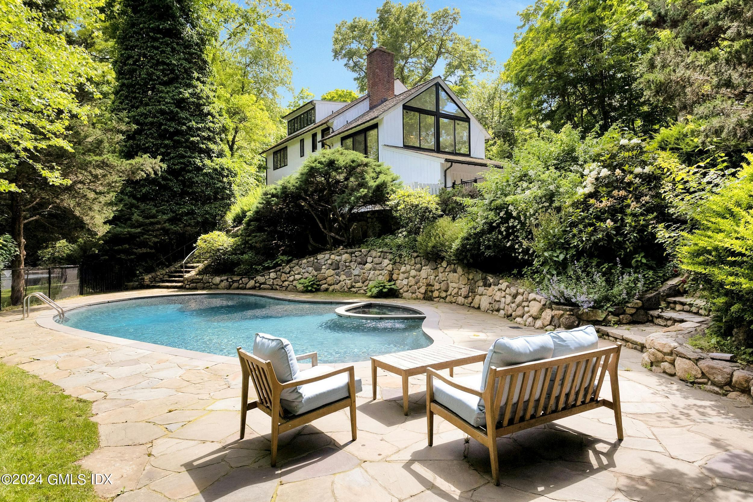 12 Guinea Road Greenwich, CT 06830 - Photo 31 of 38 a view of swimming pool with chairs and wooden fence