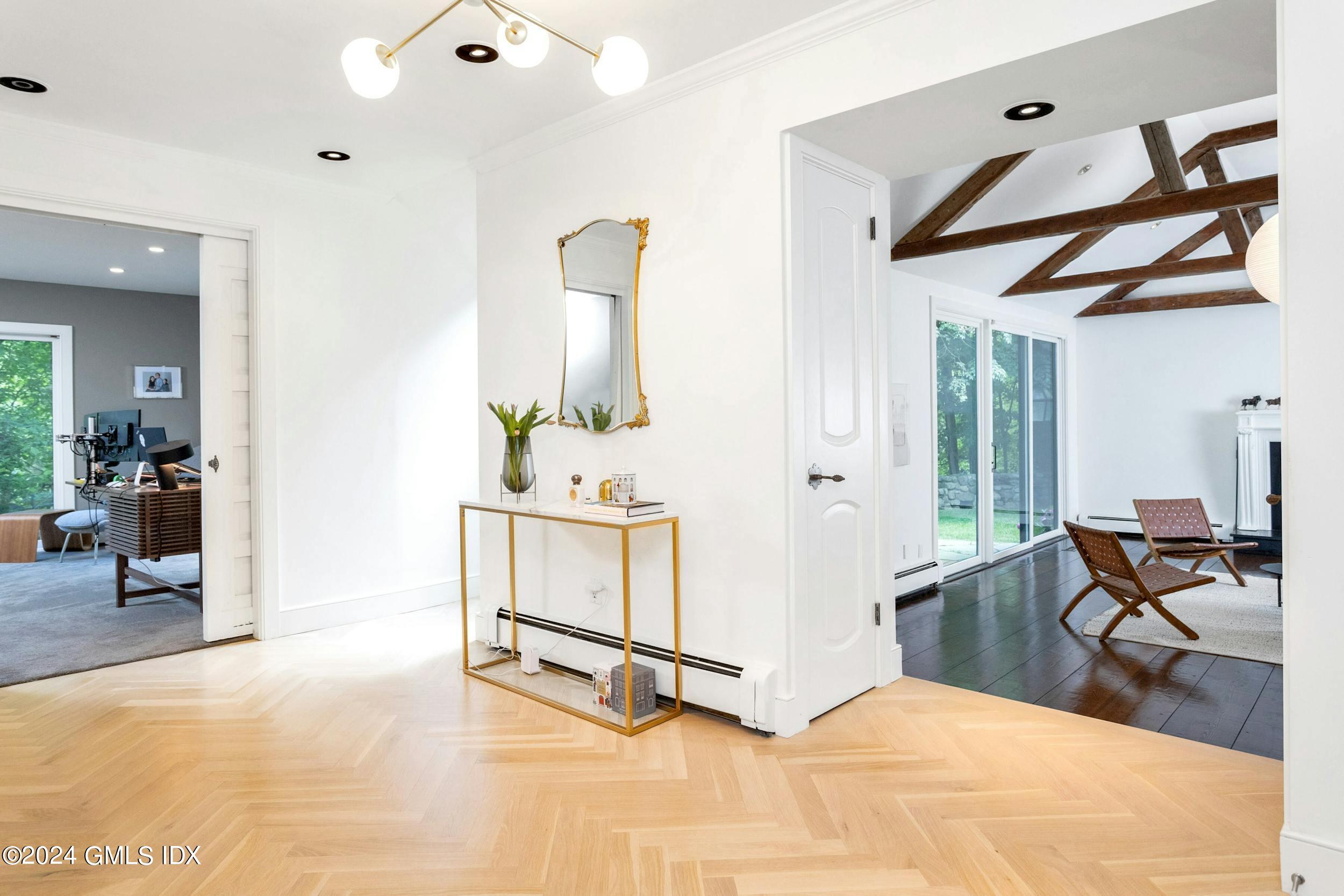 12 Guinea Road Greenwich, CT 06830 - Photo 4 of 38 a bedroom with furniture and a wooden floor