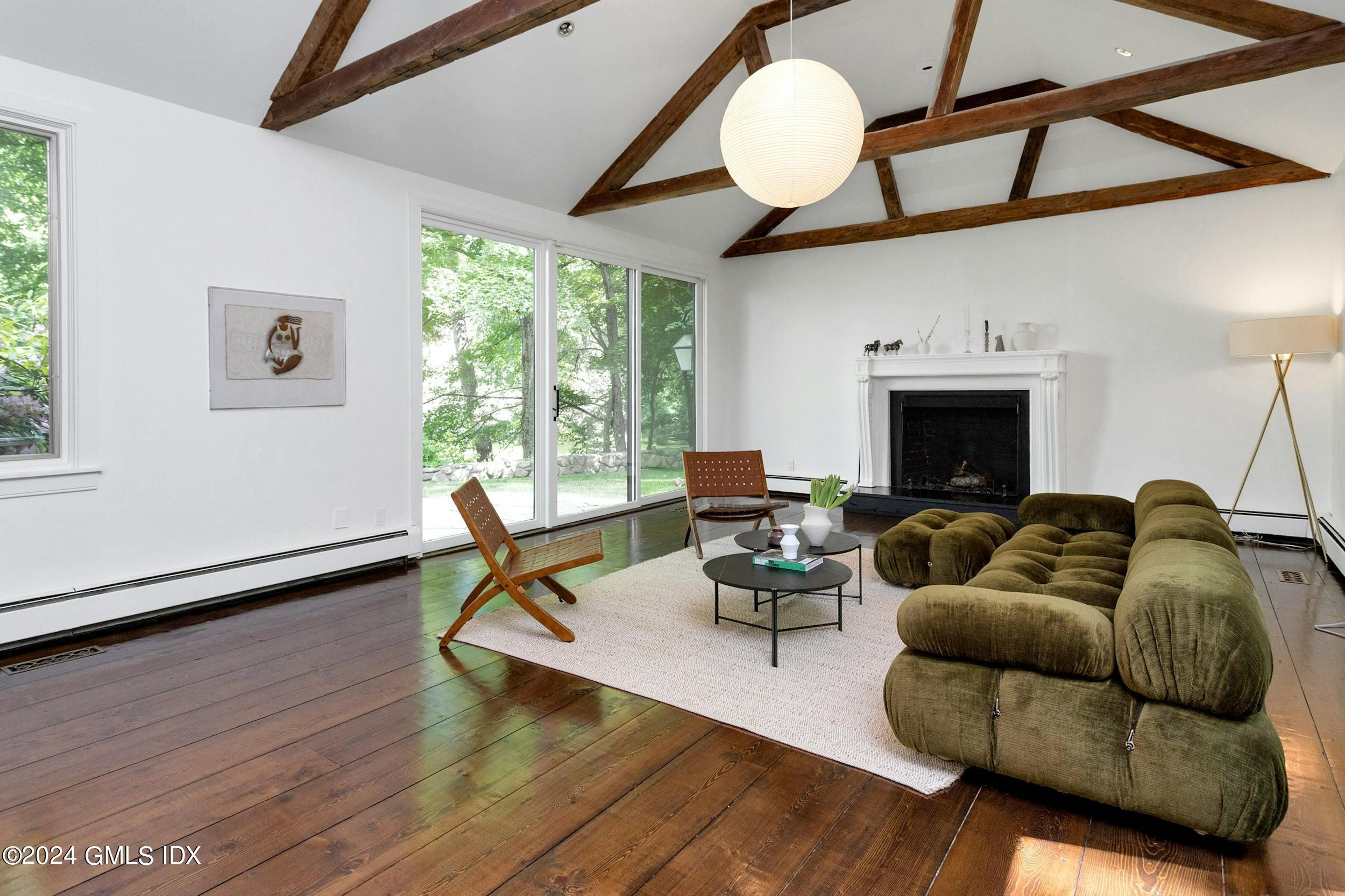 12 Guinea Road Greenwich, CT 06830 - Photo 6 of 38 a living room with furniture a flat screen tv and a large window