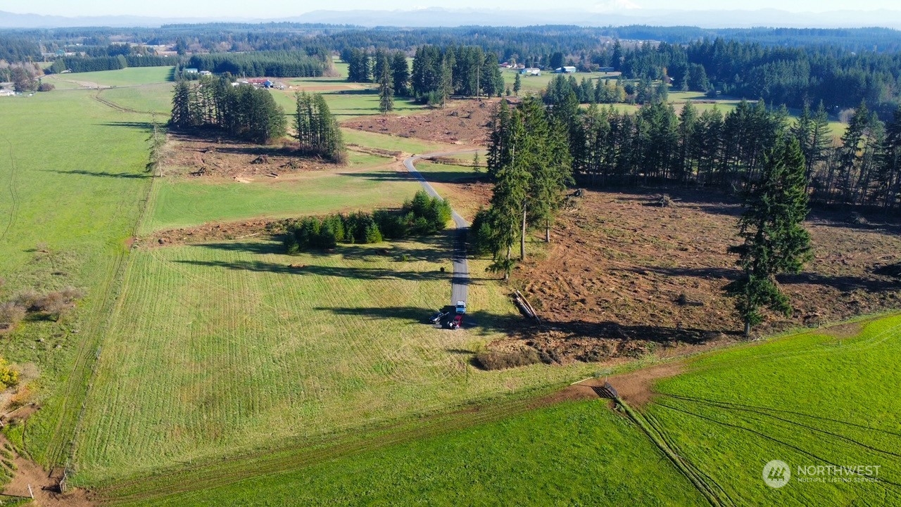 168 Racyn Lane Winlock, WA 98596 - Photo 3 of 8 an aerial view of a house with a garden and lake view
