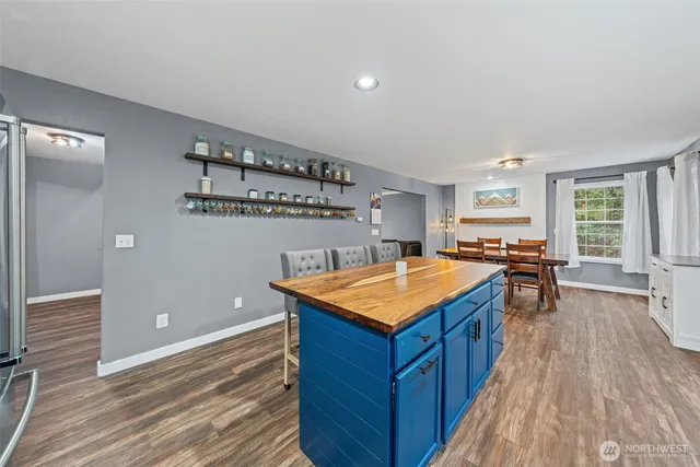 a kitchen with a counter top space and wooden floor