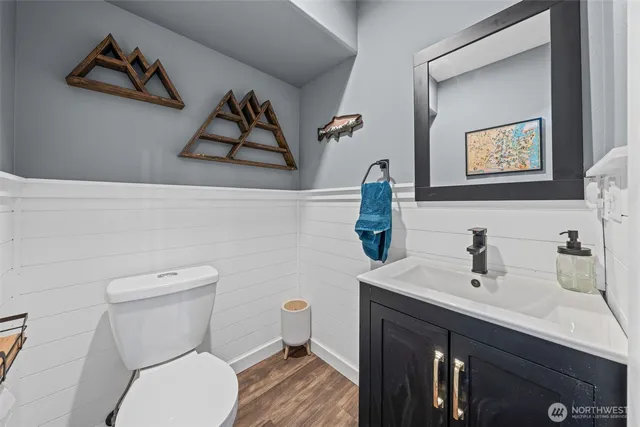 a bathroom with a toilet sink and vanity