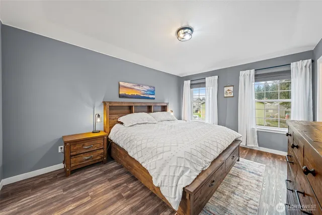 a bedroom with a bed and a large window