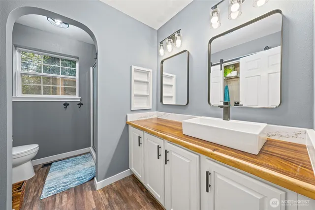 a spacious bathroom with a granite countertop sink and a mirror
