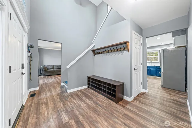 a view of a hallway with wooden floor and staircase