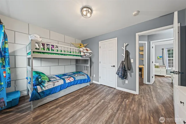 a bedroom with furniture and a wooden floor