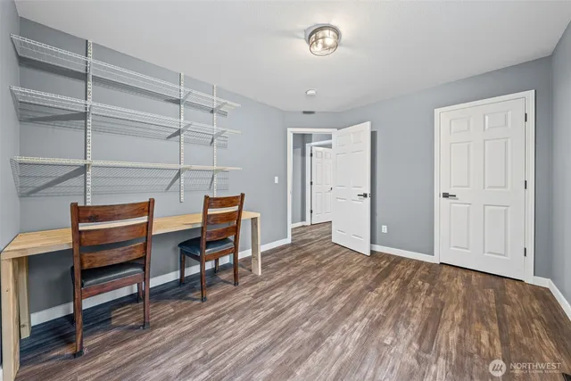 a view of room with wooden floor and furniture
