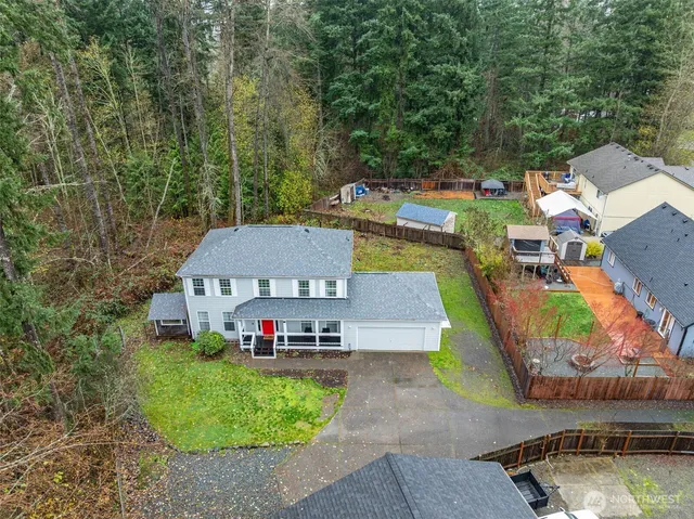 an aerial view of a house with a garden and swimming pool