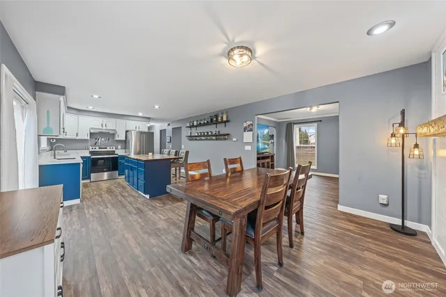 a view of a dining room with furniture and wooden floor