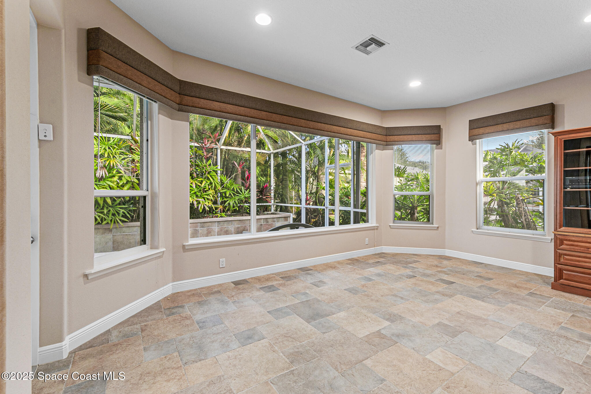 425 Baytree Drive Melbourne, FL 32940 - Photo 13 of 53 a view of an empty room with a large window and front door