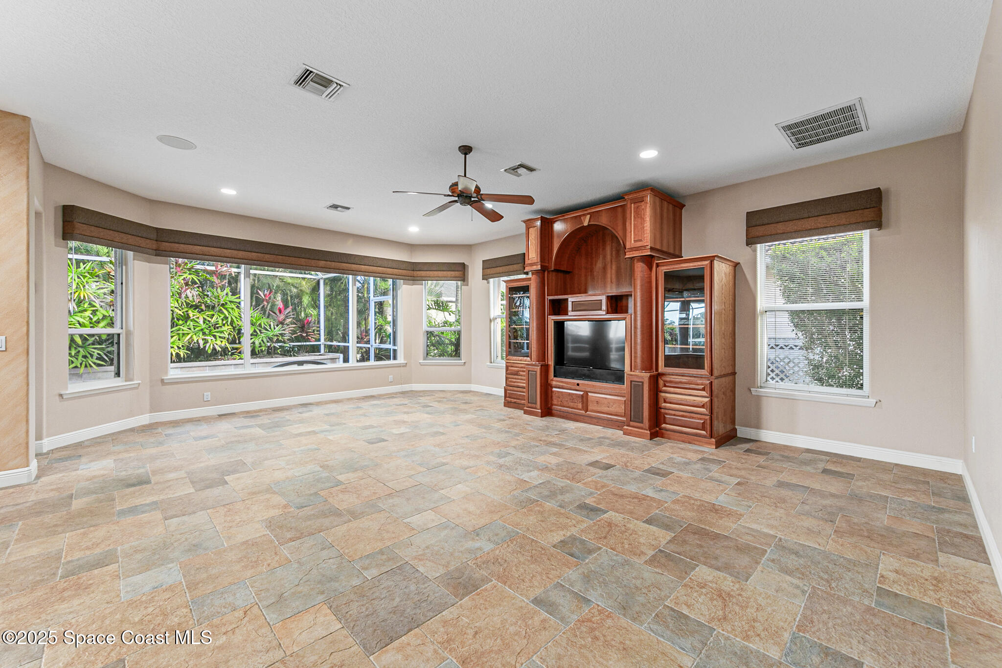 425 Baytree Drive Melbourne, FL 32940 - Photo 14 of 53 a big room with furniture and a large window