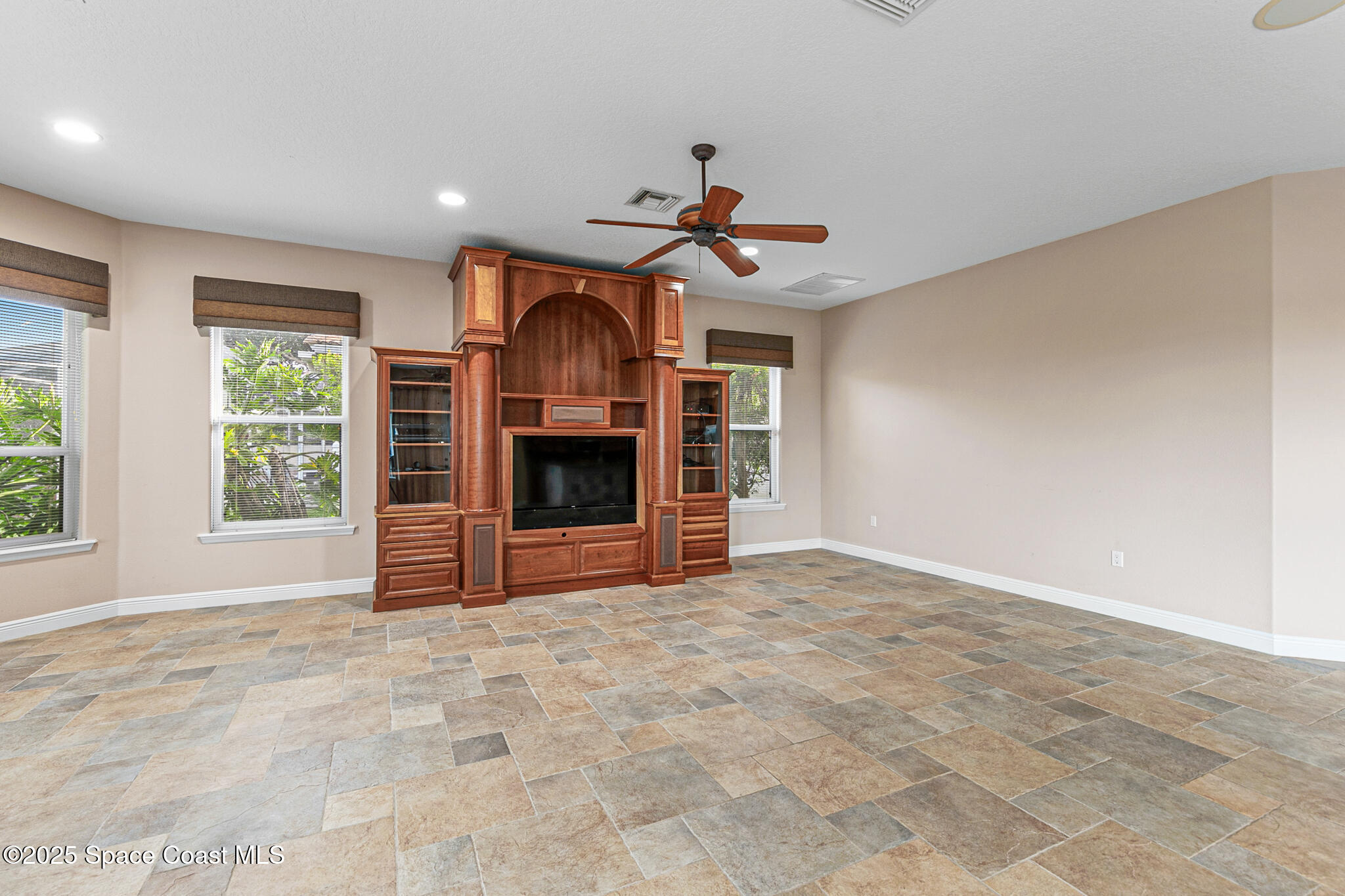 425 Baytree Drive Melbourne, FL 32940 - Photo 15 of 53 a view of a livingroom with a ceiling fan and window