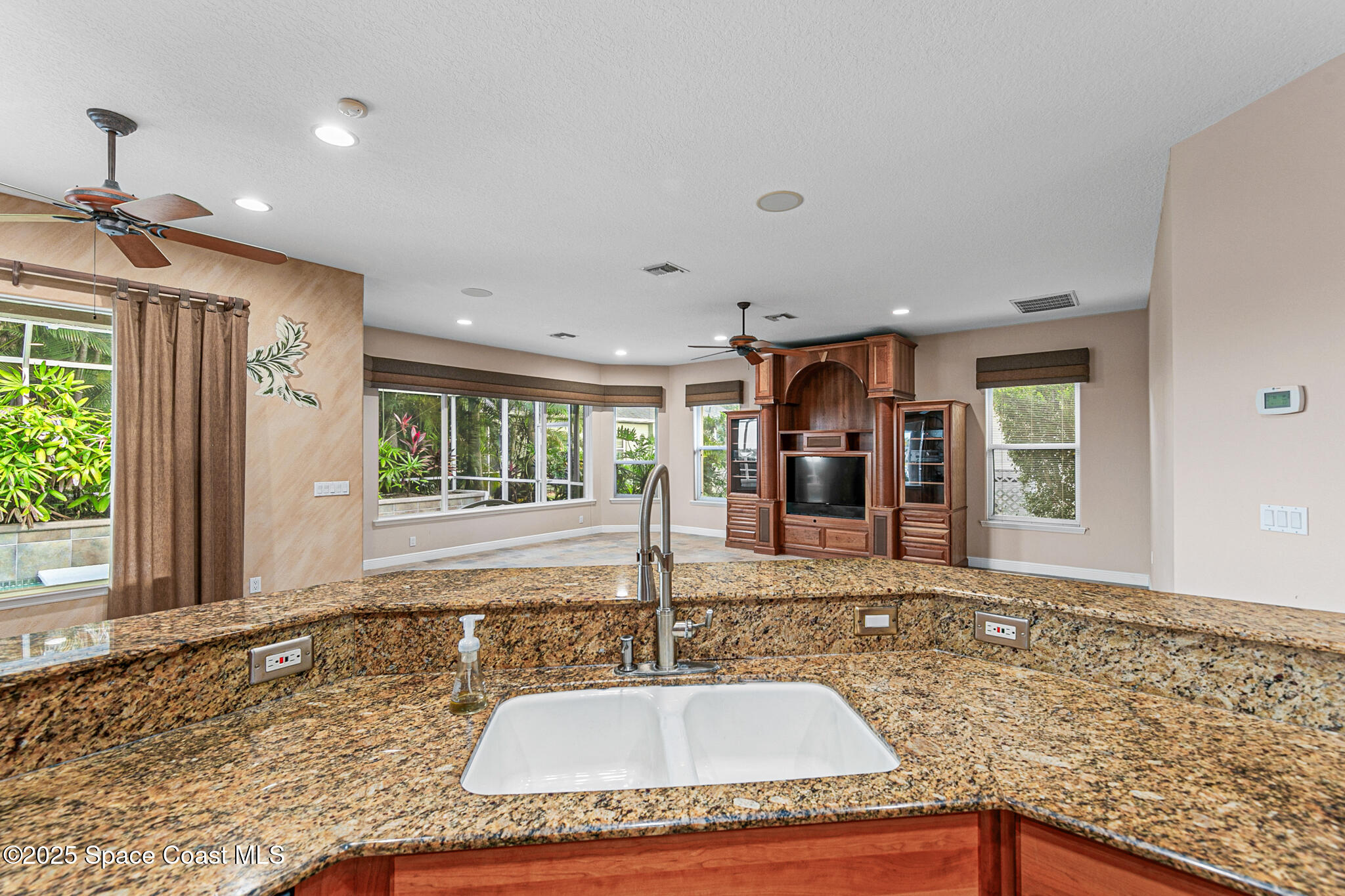 425 Baytree Drive Melbourne, FL 32940 - Photo 17 of 53 a view of a kitchen with a sink and dining table