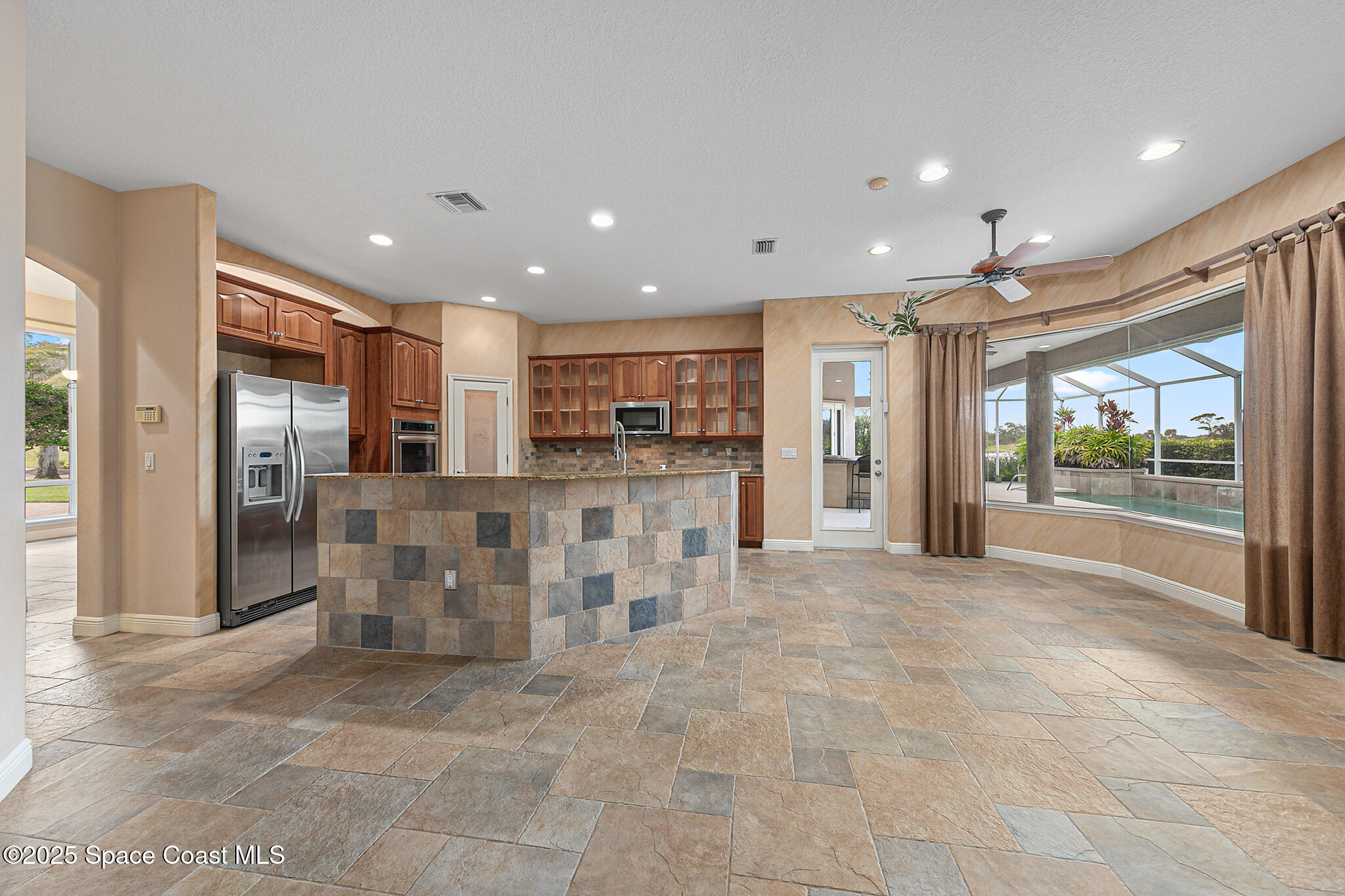 425 Baytree Drive Melbourne, FL 32940 - Photo 18 of 53 a view of kitchen with stainless steel appliances kitchen island granite countertop a refrigerator and a sink