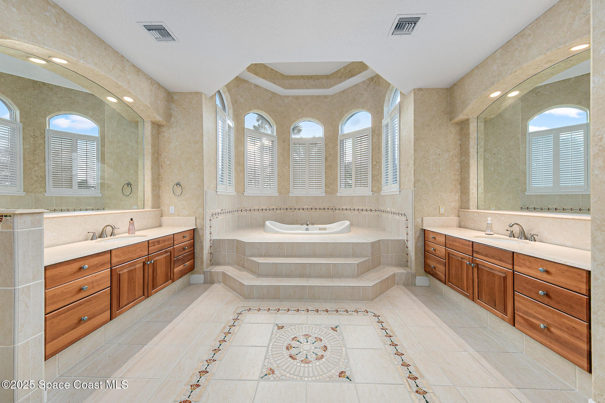 425 Baytree Drive Melbourne, FL 32940 - Photo 21 of 53 a spacious bathroom with a tub sink and mirror