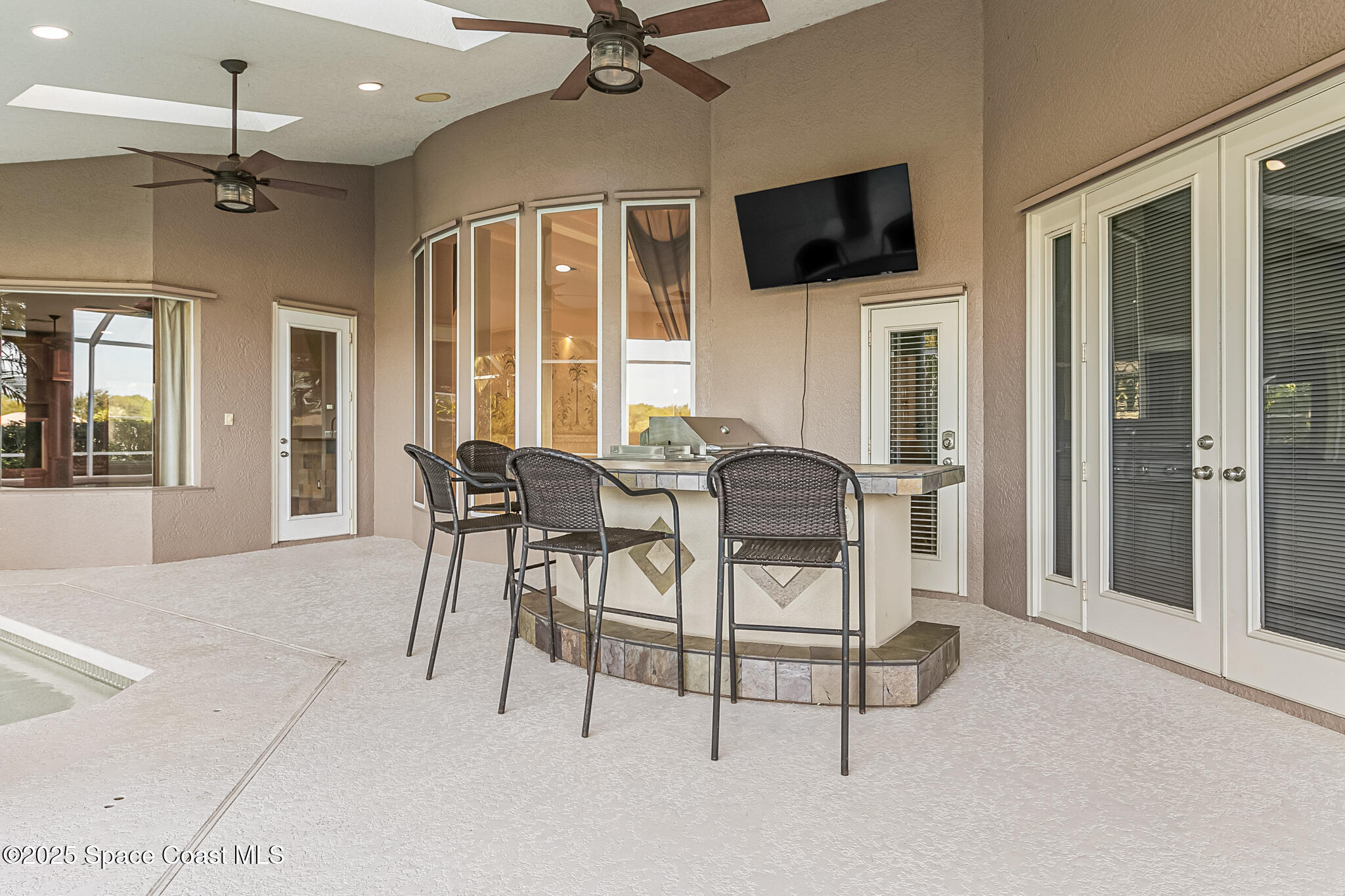 425 Baytree Drive Melbourne, FL 32940 - Photo 32 of 53 a view of a livingroom with furniture and a flat screen tv
