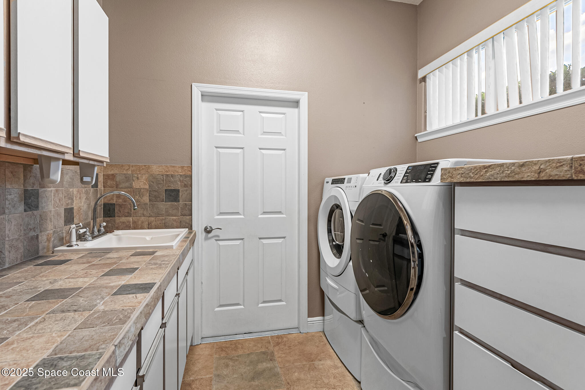 425 Baytree Drive Melbourne, FL 32940 - Photo 36 of 53 a utility room with dryer and washer