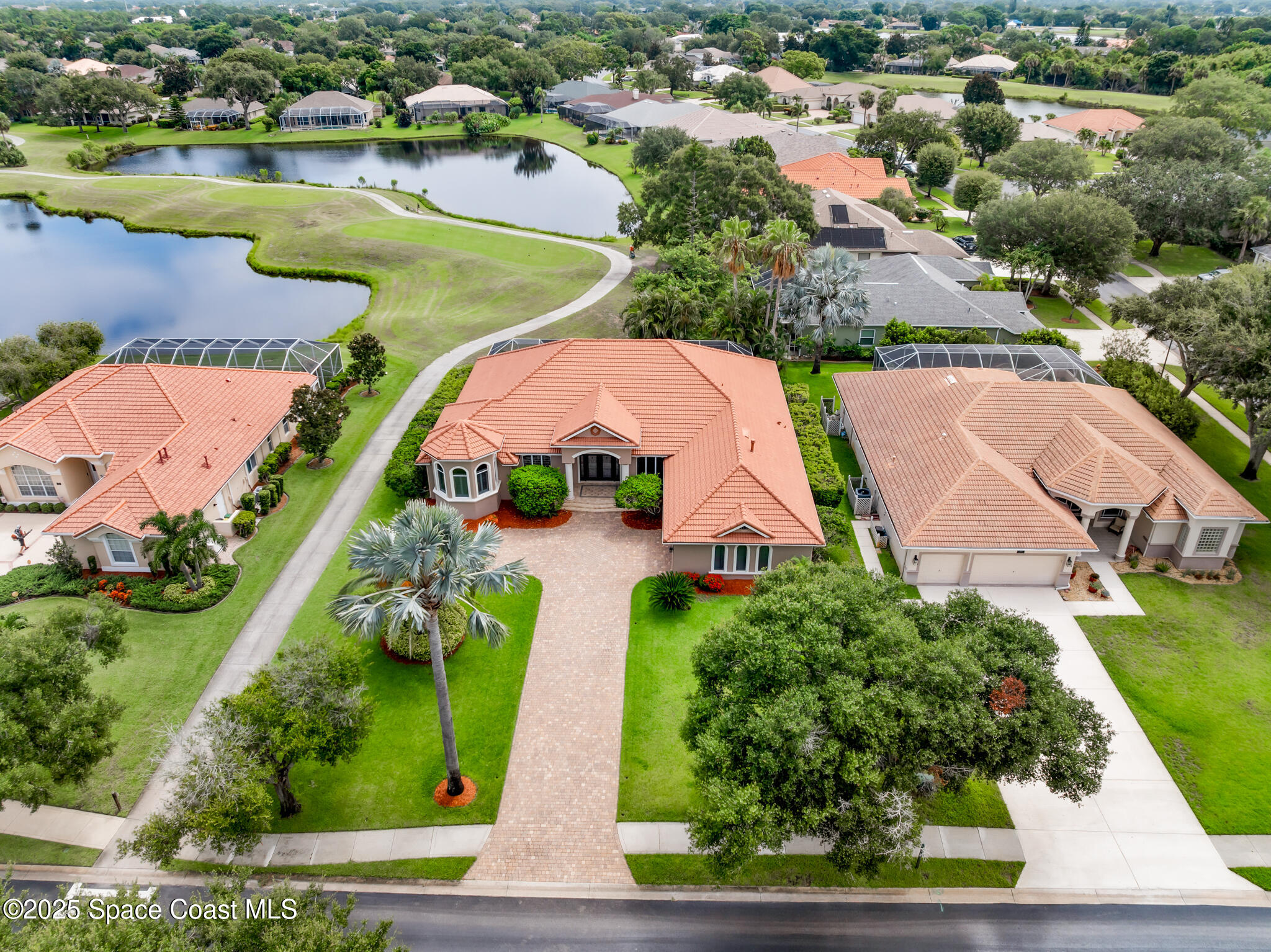 425 Baytree Drive Melbourne, FL 32940 - Photo 38 of 53 an aerial view of residential houses with outdoor space and lake view