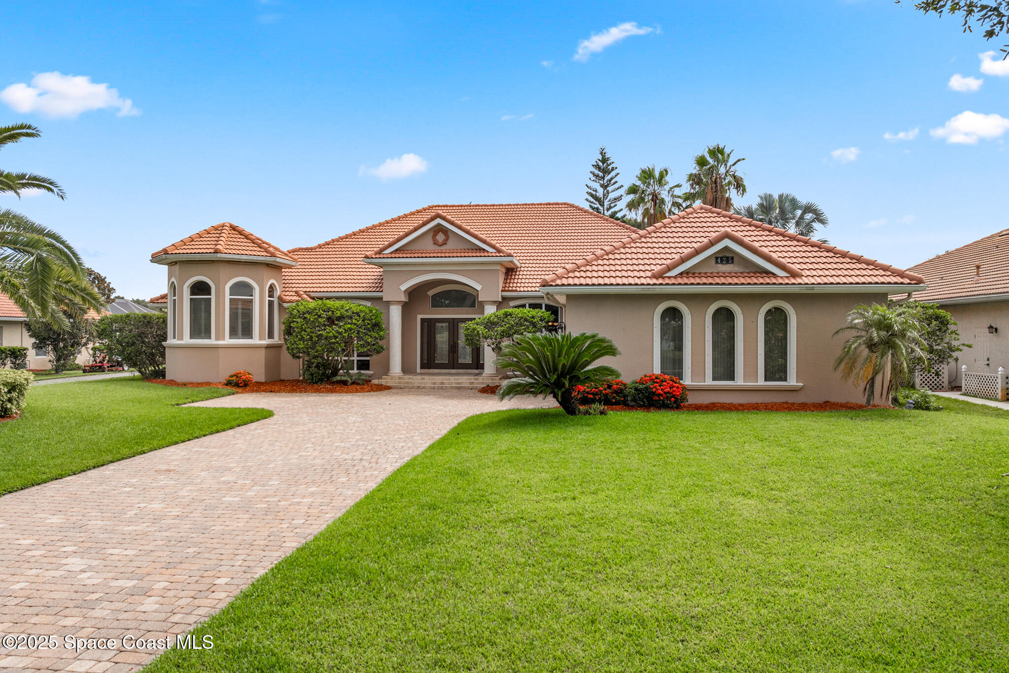425 Baytree Drive Melbourne, FL 32940 - Photo 49 of 53 a front view of a house with a garden