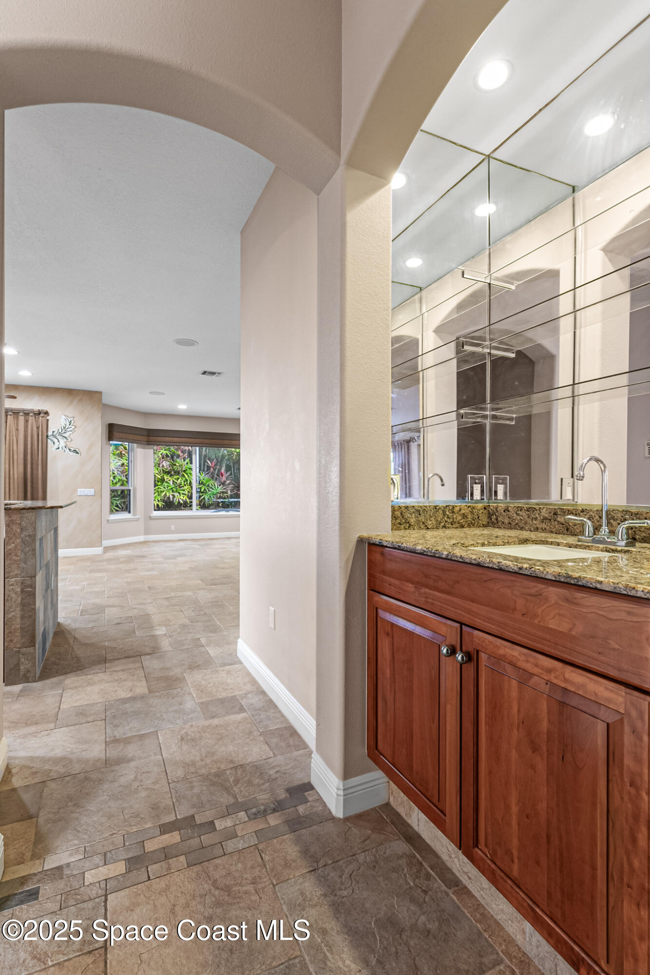 425 Baytree Drive Melbourne, FL 32940 - Photo 10 of 53 a bathroom with a granite countertop sink and a mirror