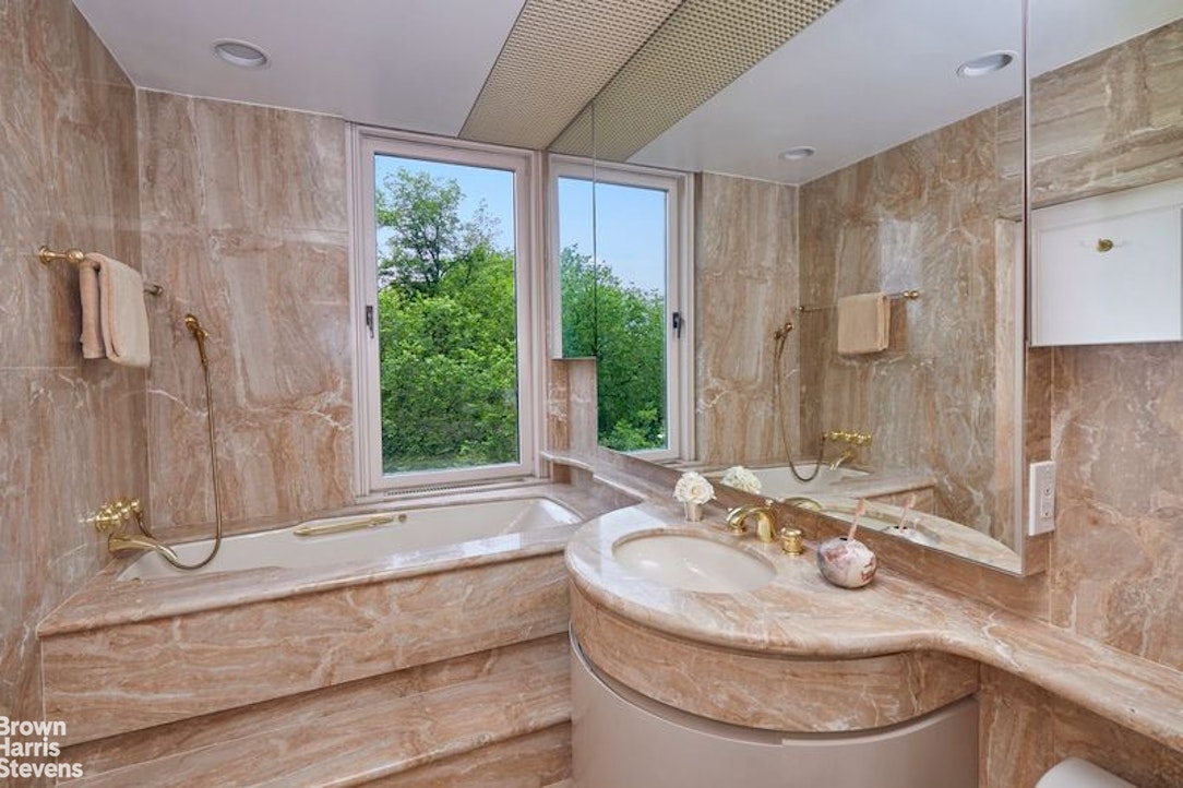 1133 5th Avenue, Unit 7A Manhattan, NY 10128 - Photo 11 of 12 a bathroom with a sink and a mirror