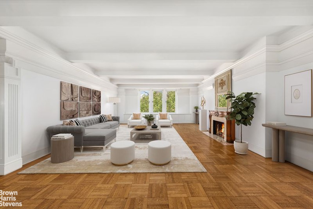 1133 5th Avenue, Unit 7A Manhattan, NY 10128 - Photo 2 of 12 a living room with fireplace furniture and a large window