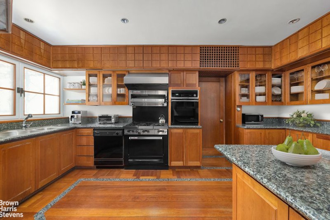1133 5th Avenue, Unit 7A Manhattan, NY 10128 - Photo 6 of 12 a kitchen with stainless steel appliances granite countertop a sink stove and refrigerator