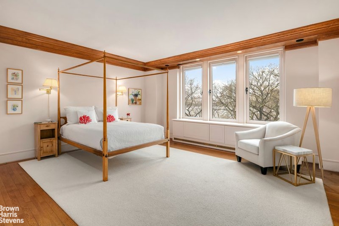 1133 5th Avenue, Unit 7A Manhattan, NY 10128 - Photo 9 of 12 a bedroom with a bed and a chair