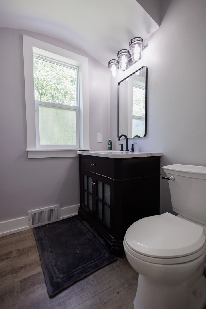 855 East 5000S Road Kankakee, IL 60901 - Photo 21 of 48 a bathroom with a toilet a sink a mirror a window and vanity