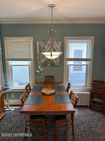 a dining room with a table and chairs