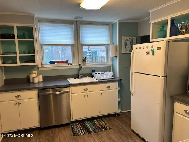a kitchen with stainless steel appliances a refrigerator sink and cabinets