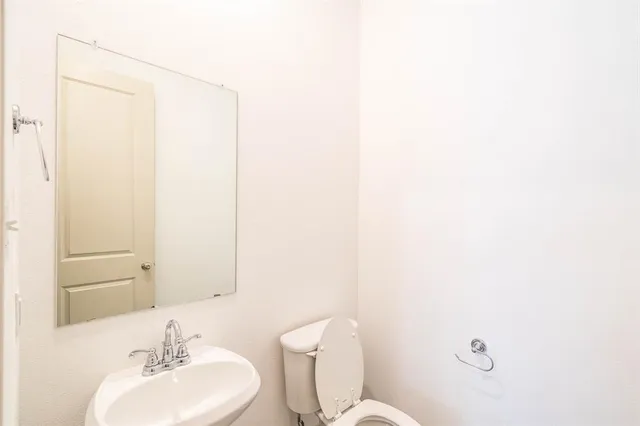 a bathroom with a sink a mirror and a toilet