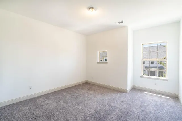 an empty room with windows and closet