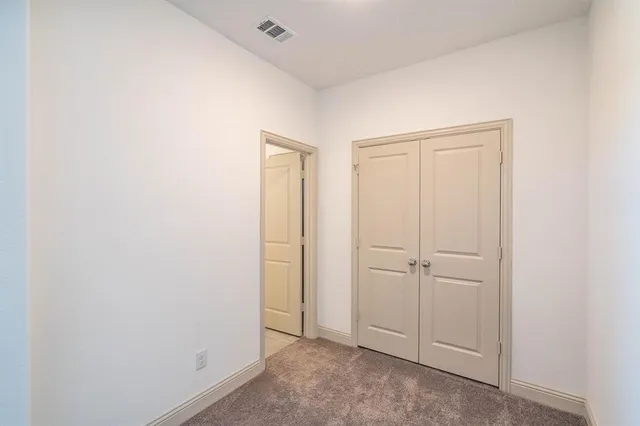an empty room with closet area