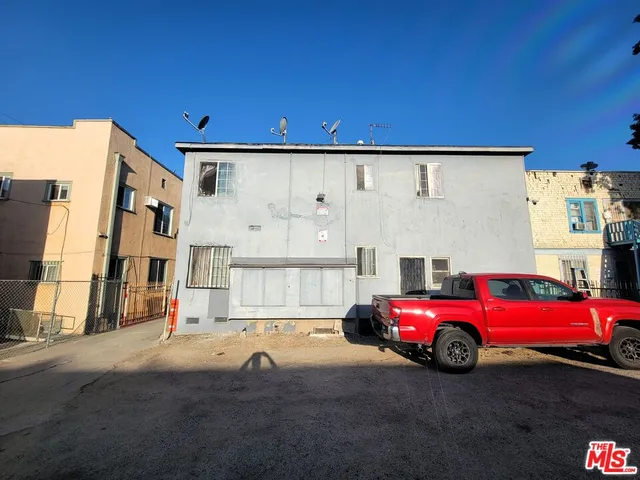 a red car parked in front of a building