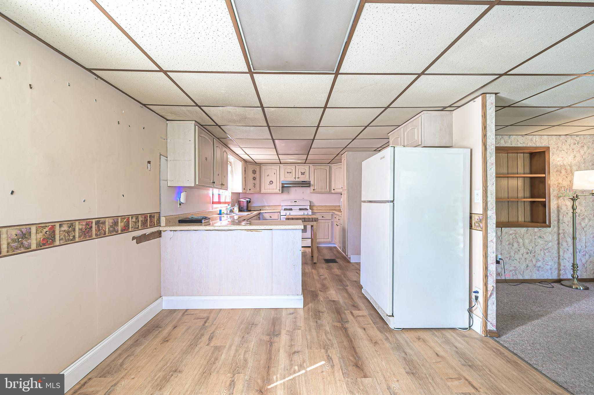 311 Woodruff Carmel Road Bridgeton, NJ 08302 - Photo 12 of 40 a kitchen with stainless steel appliances a refrigerator and a stove top oven