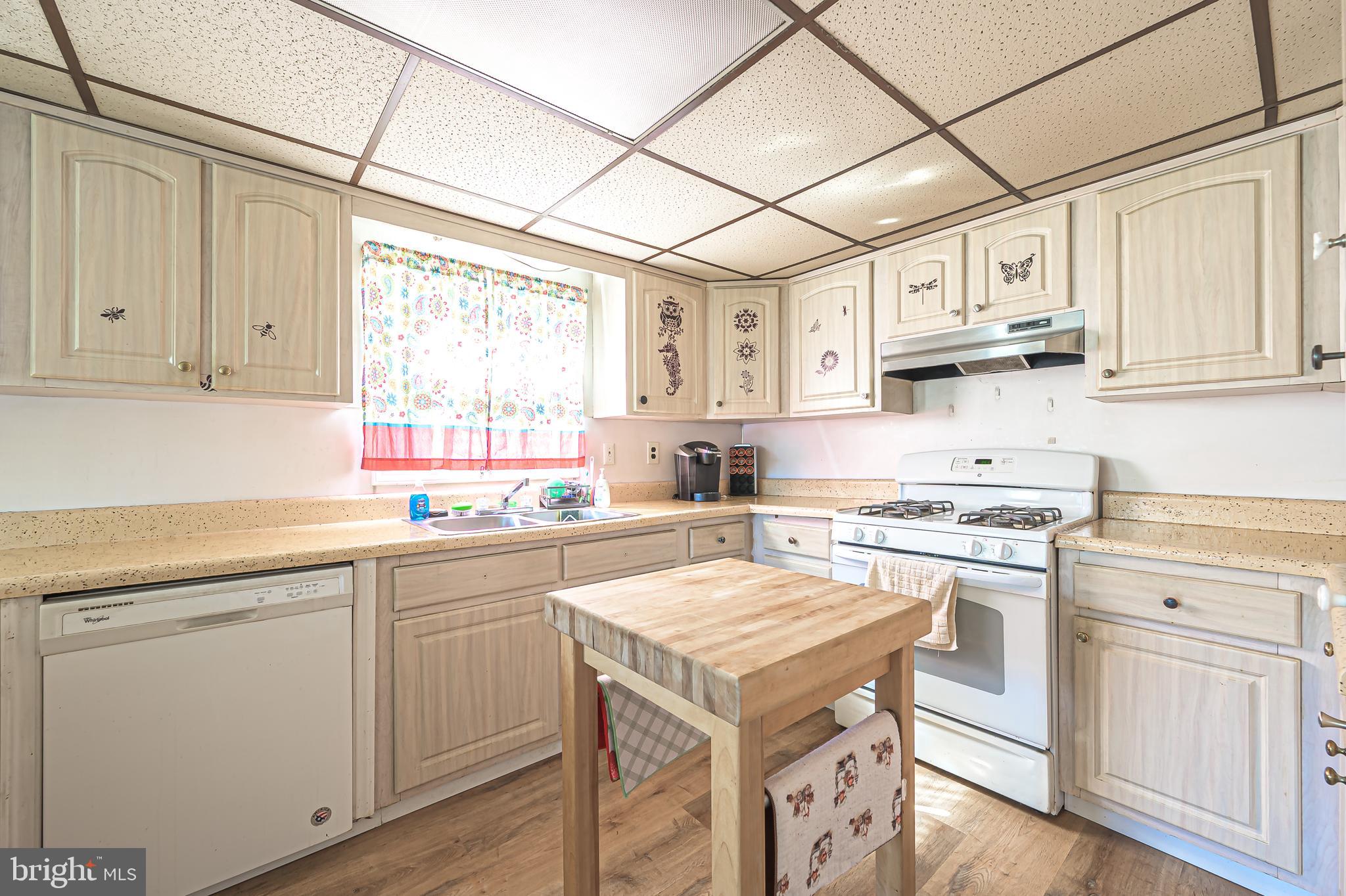 311 Woodruff Carmel Road Bridgeton, NJ 08302 - Photo 15 of 40 a kitchen with cabinets appliances a sink and a window