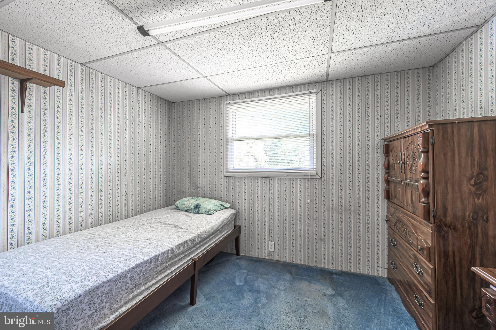 311 Woodruff Carmel Road Bridgeton, NJ 08302 - Photo 22 of 40 a bedroom with a bed and wooden floor