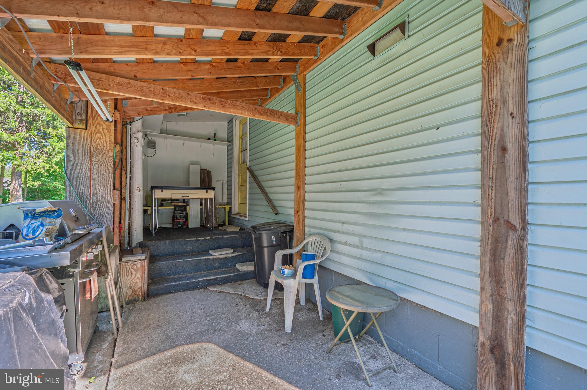 311 Woodruff Carmel Road Bridgeton, NJ 08302 - Photo 23 of 40 a view of a porch with furniture and a potted plant