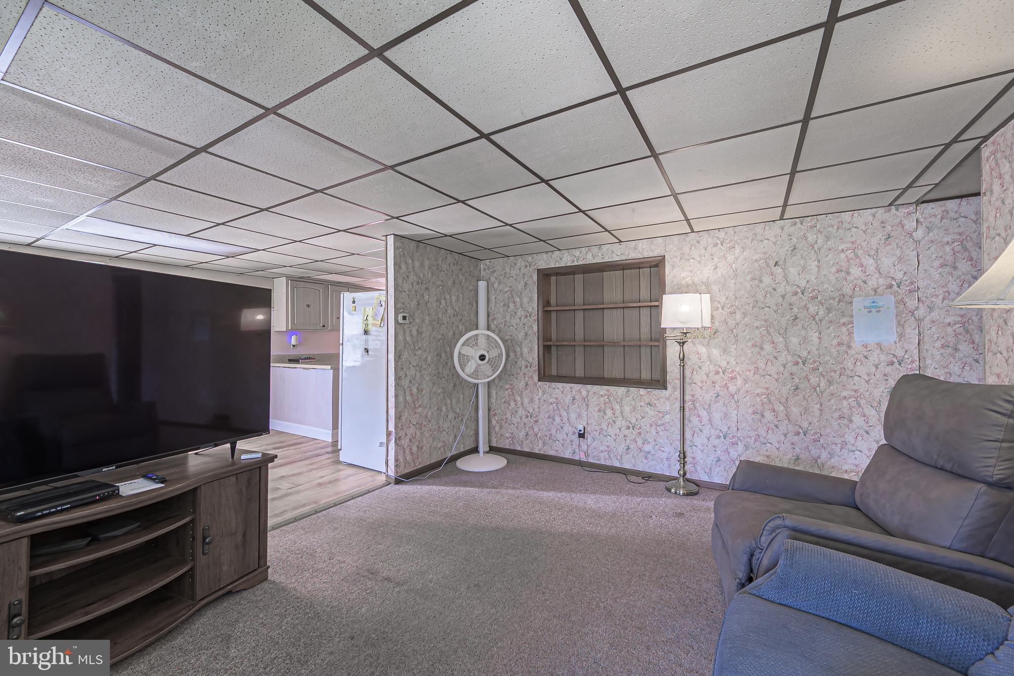 311 Woodruff Carmel Road Bridgeton, NJ 08302 - Photo 8 of 40 a living room with furniture and a flat screen tv