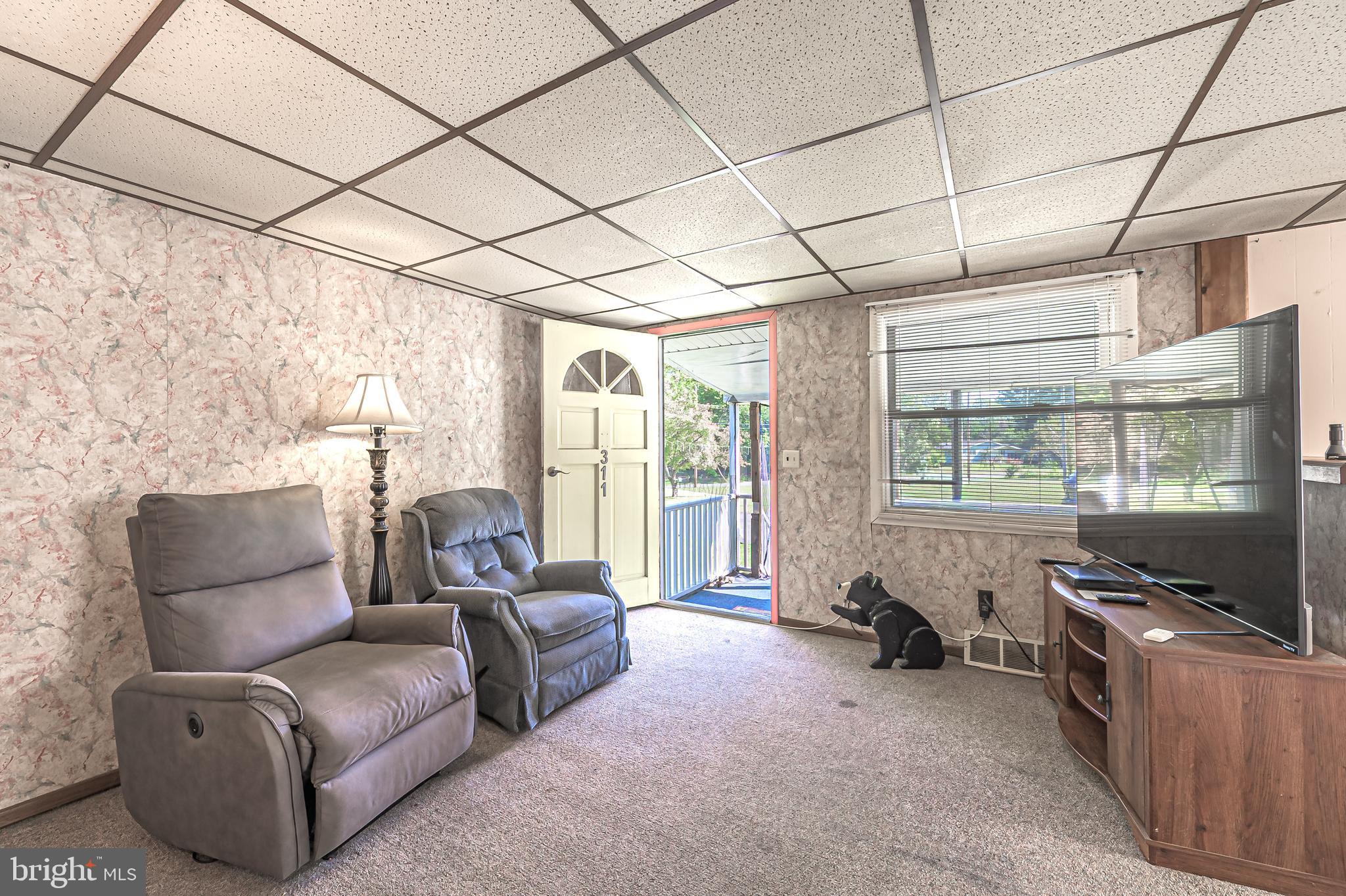 311 Woodruff Carmel Road Bridgeton, NJ 08302 - Photo 9 of 40 a living room with furniture and a flat screen tv